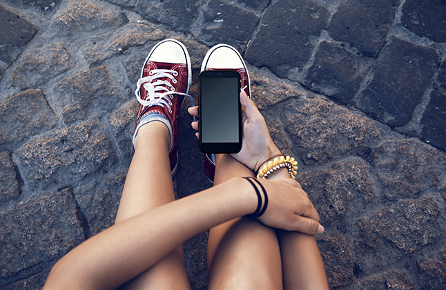 student looking at cell phone