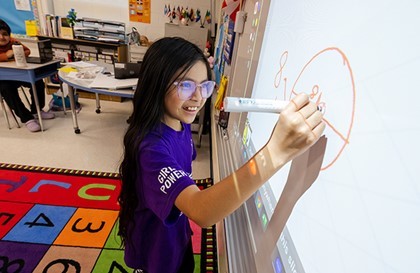 student at interactive whiteboard