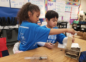 two students exploring soil stability