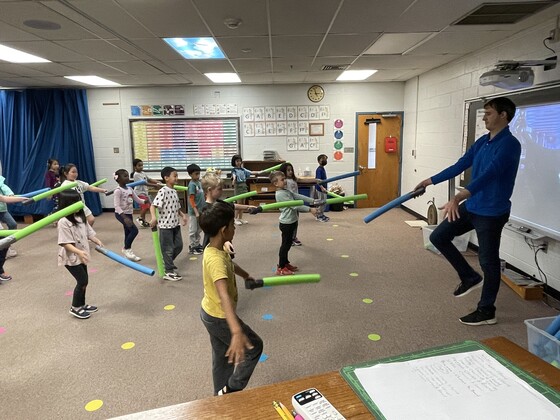 students in music class with pool noodles