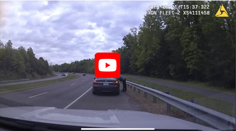 Police officer by stopped car on Fairfax County Parkway