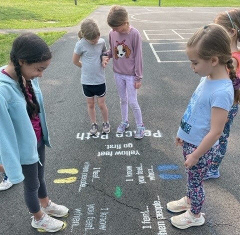 image of students walking our playground peace path