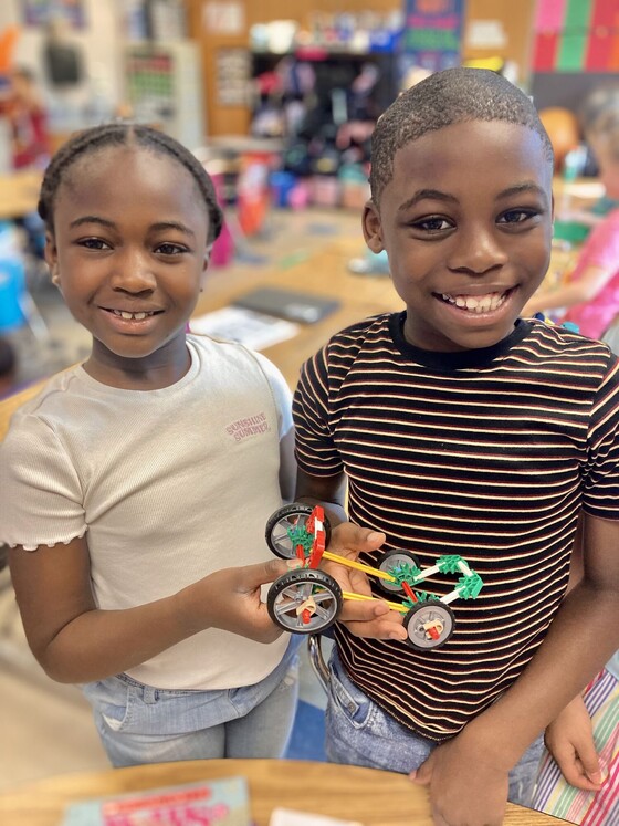 smiling students with toy