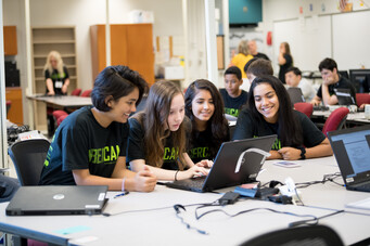 4 girls looking at laptop