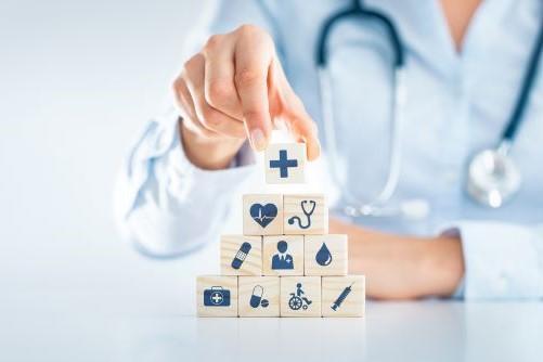 photo of person placing health-related blocks in shape of a pyramid