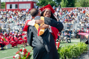 student hugging administrator at graduation