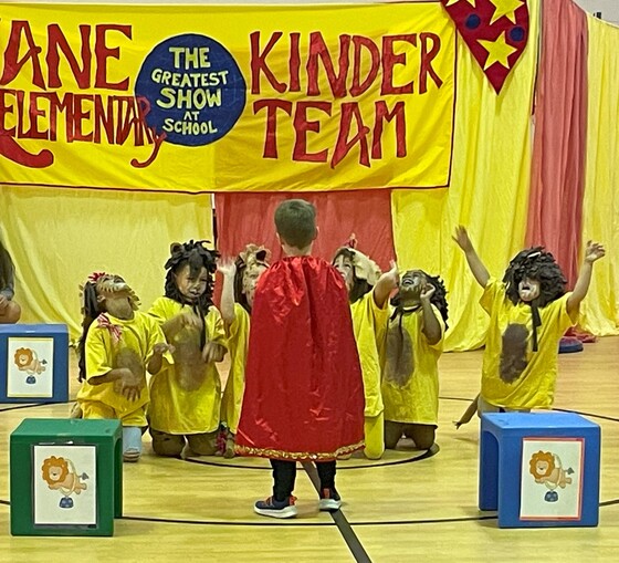 Students dressed as lions and lion tamer