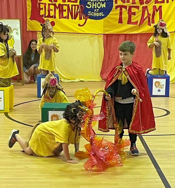 Students dressed as lions and lion tamer