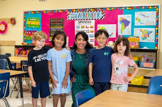 students smiling with teacher