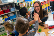 teacher giving high-five to students