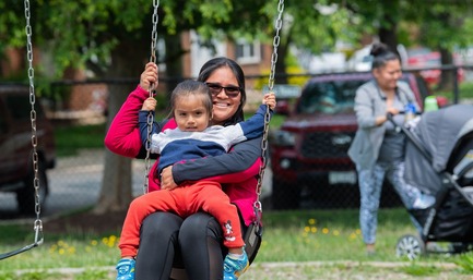 parent with child on swing
