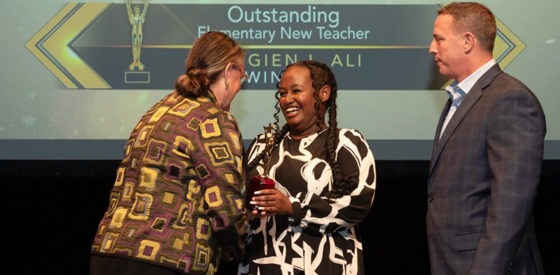 2022-23 Outstanding Elementary School New Teacher Elogien Ali receiving her award from Superintendent Reid.