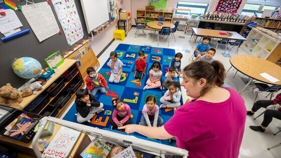 Kindergarten teacher standing in front of students.