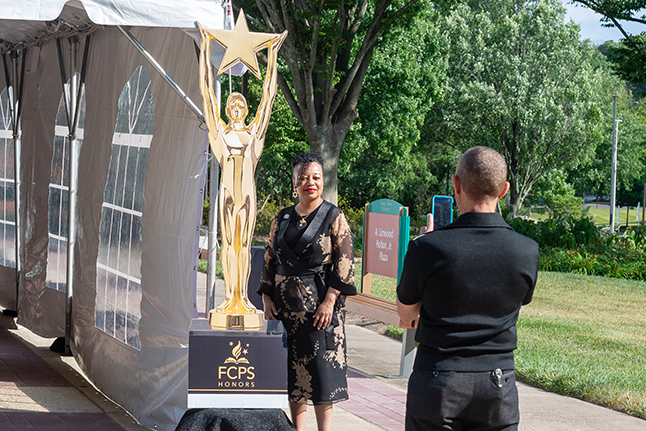 Teacher posing with award