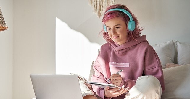 girl on laptop with headphones