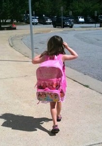 Student wearing backpack walking to school