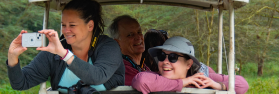 A group of adults on a riding in off-road vehicle