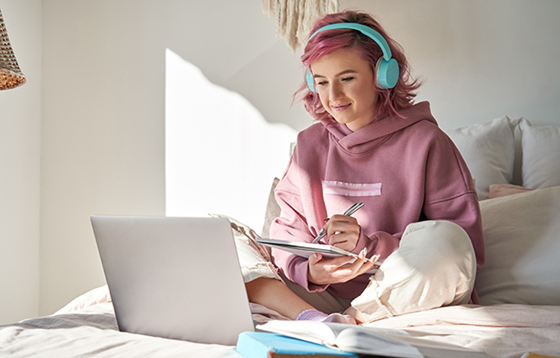 Student wearing headphones sitting in front of laptop