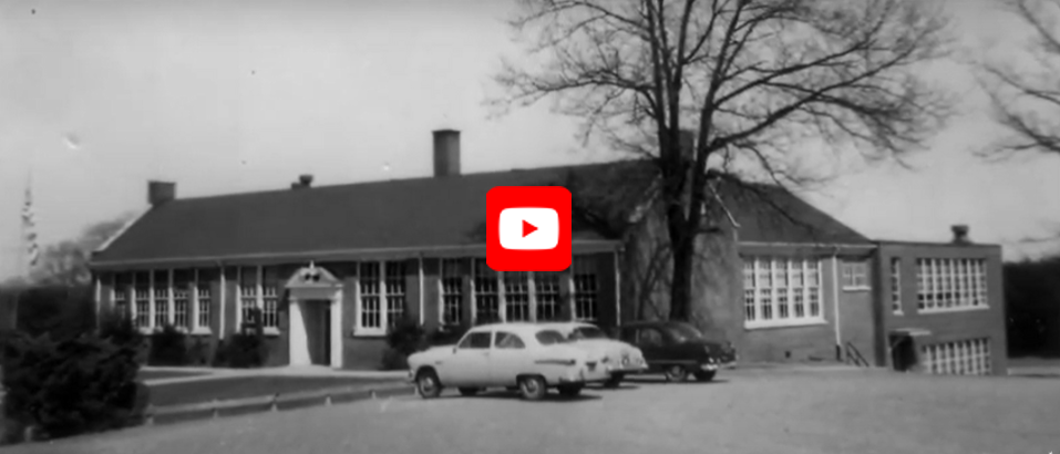 Old Fairview Elementary School with cars parked in front