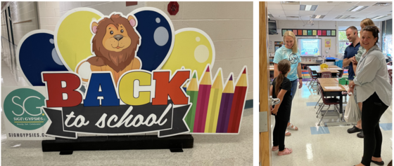 back to school sign and family visiting a classroom