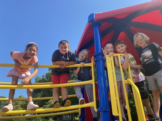 3rd grade students smiles from the playground equipment