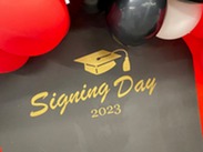Genesys Works 2023 Signing Day graphic which includes a mortar board and tassel in gold letters on a black background .