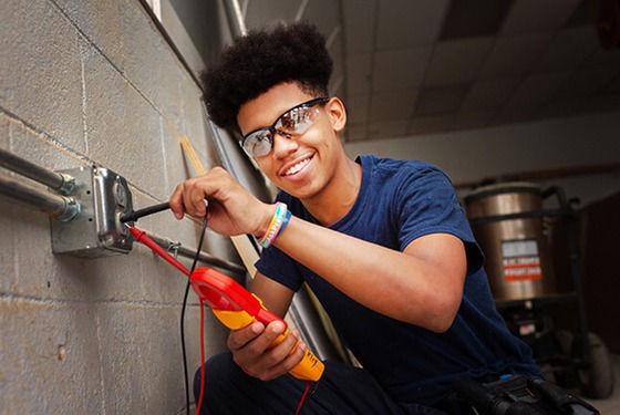 Student testing electrical socket