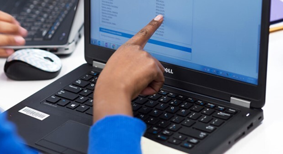 student pointing to laptop screen