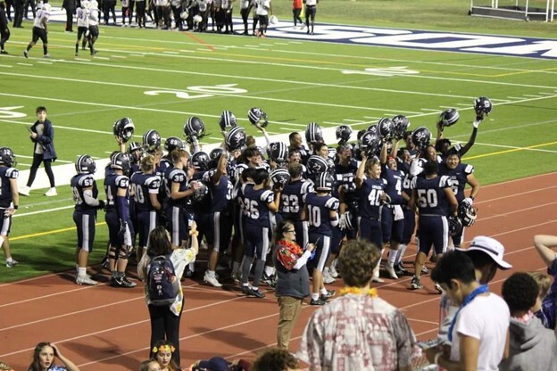 Varsity Football celebrating their win at Feeder Night