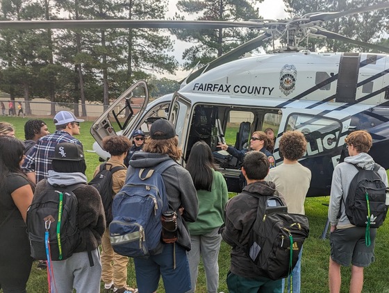 Students around police helicopter