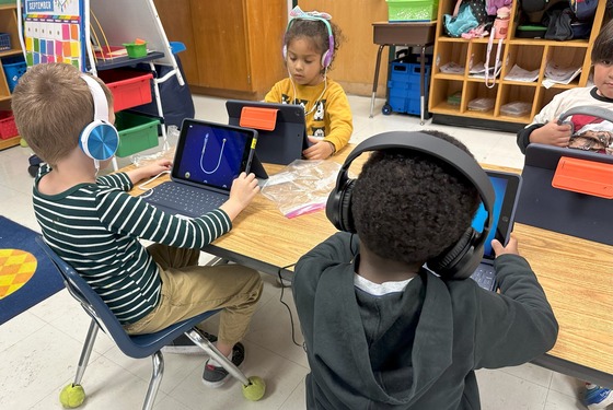 Four children working on ipads