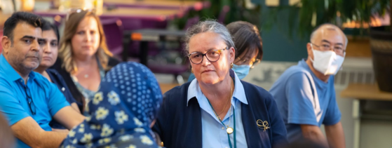 Dr. Reid listening to a person speak