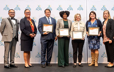 West Springfield High School staff holding awards and standing beside Leadership Team members 