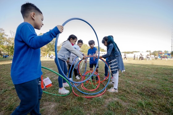 Students playing together with hula hoops