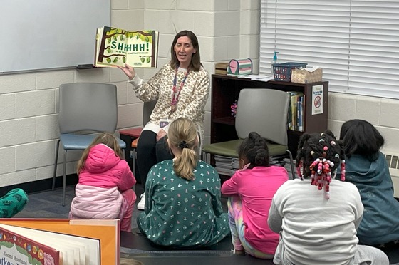 Teacher reading to students in the library