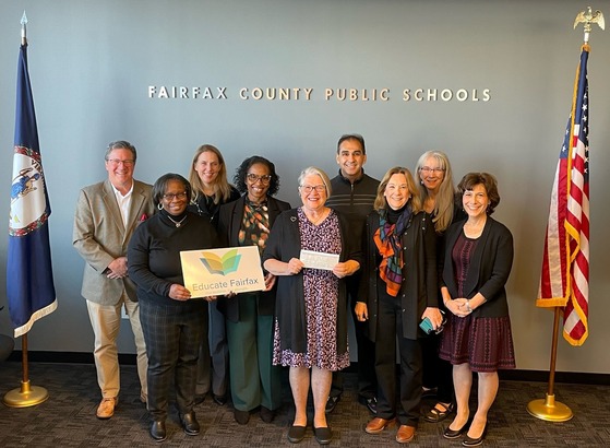 GrandInvolve Executive Director Dorothy Keenan and members of the GrandInvolve board presenting a $39,380 check to Educate Fairfax.