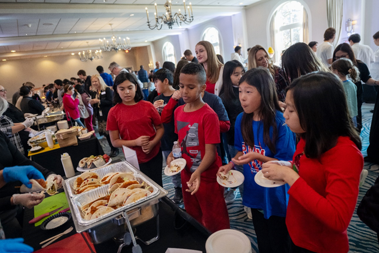 photo of group of students sampling food at a food services  event