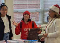 girl waiving holding toy