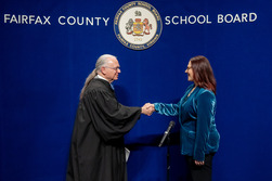 Melanie Meren shaking hands with judge following oath of office