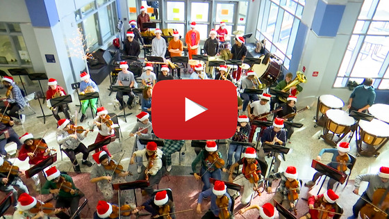 Screenshot of the TJ Orchestra holiday performance with YouTube play button on it.