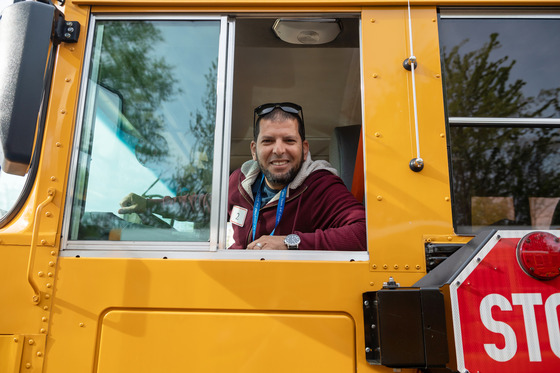 a bus driver looks out his window
