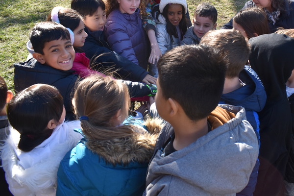 image of students huddle up before recess