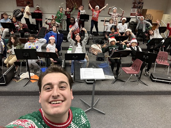 Band students preparing for their holiday concert with their teacher