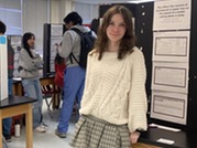 Student in front of science project