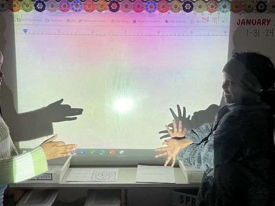 students creating shadow puppets 