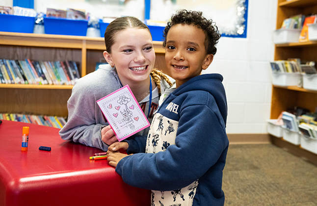 two students make a valentine card together