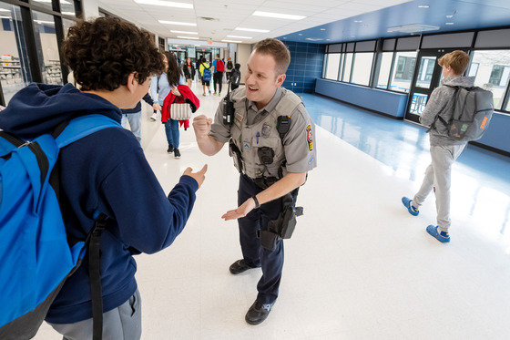 Student fist-bumping with School Resource Officer