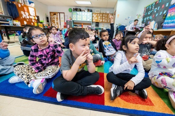 Kindergarten students sitting on floor