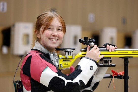 Student holding air rifle