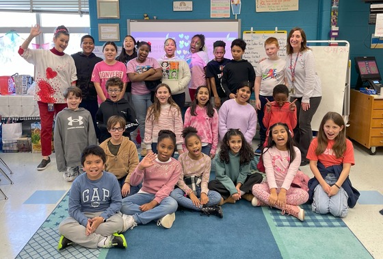 Class picture of students dressed up for Valentine's Day